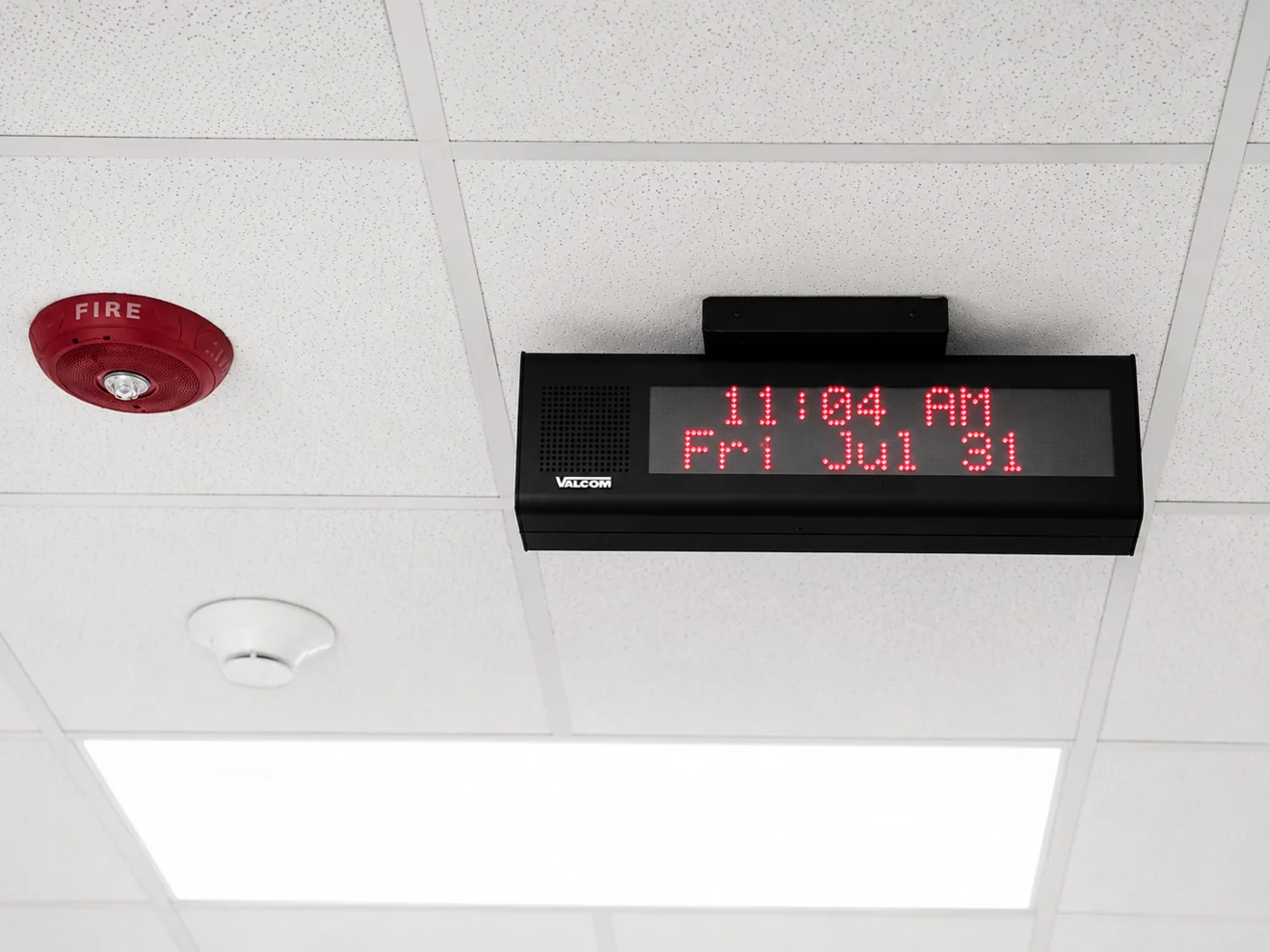 Valcom ceiling-mounted visual messaging display near fire alarm equipment in a Central Illinois school