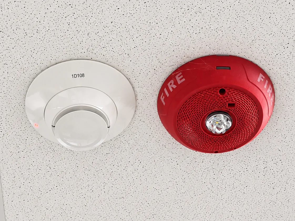 Smoke detector and red fire alarm horn-strobe installed at a church in Pekin Illinois