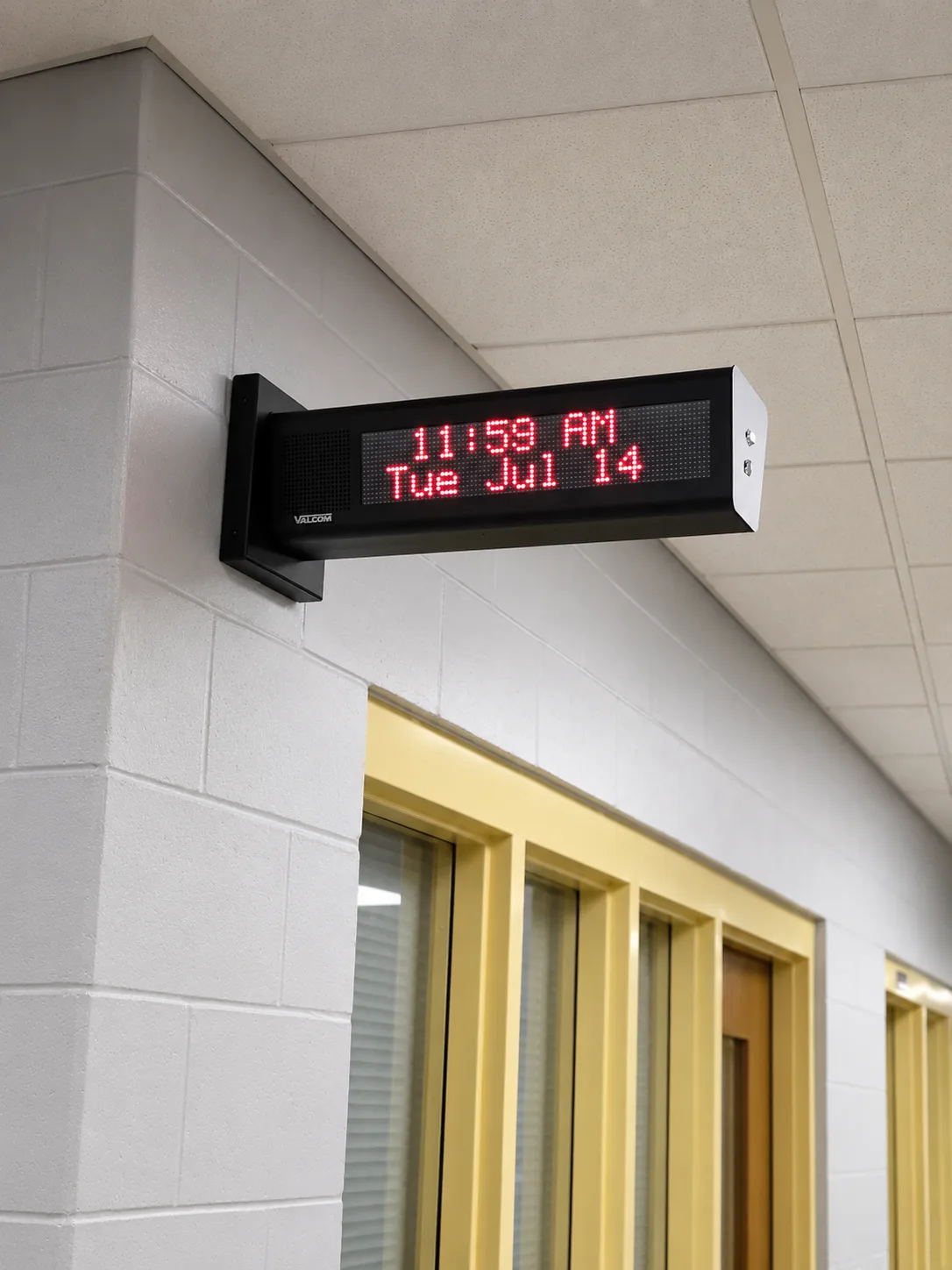 Completed Valcom dual-sided speaker clock operating in a Wilson School hallway